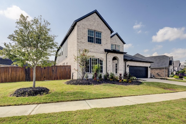 view of front of home with a garage and a front lawn