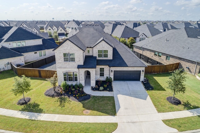 view of front of property featuring a front lawn and a garage