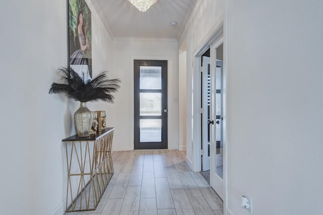 interior space featuring french doors, crown molding, and a notable chandelier