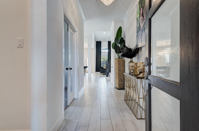 corridor featuring baseboards and crown molding