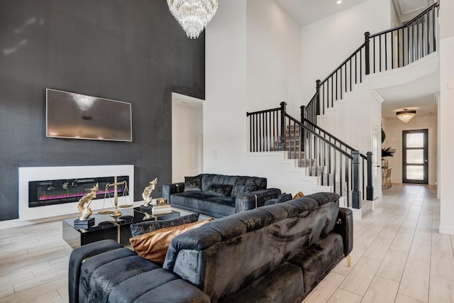 living room with a high ceiling and an inviting chandelier