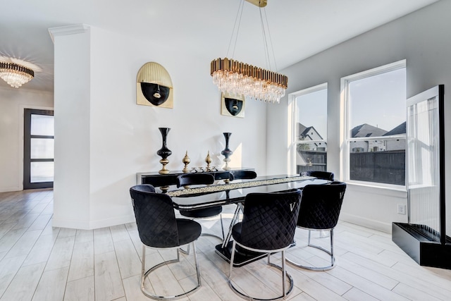 dining space featuring an inviting chandelier, wood finished floors, and baseboards