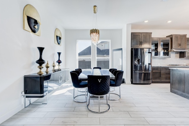 dining room with a chandelier, wood finish floors, recessed lighting, and baseboards