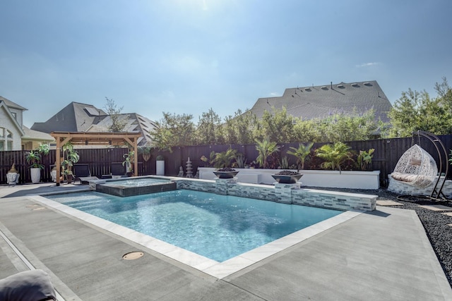 view of pool featuring a pool with connected hot tub, a patio, and a fenced backyard