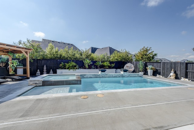 view of swimming pool with a fenced backyard, a pool with connected hot tub, and a patio area