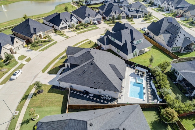 bird's eye view featuring a residential view and a water view