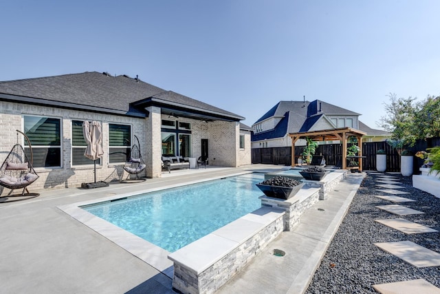 view of pool featuring a patio area, a fenced in pool, a fenced backyard, a ceiling fan, and a gazebo