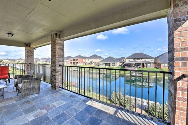 balcony featuring a water view and an outdoor hangout area