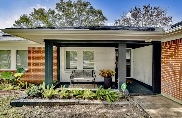 view of exterior entry with covered porch