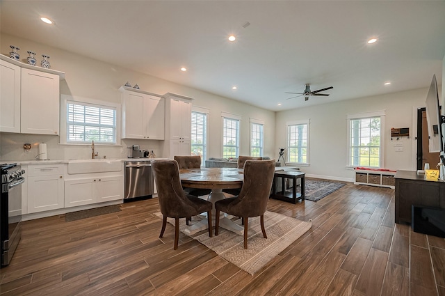 dining area featuring ceiling fan, sink, and dark wood-type flooring