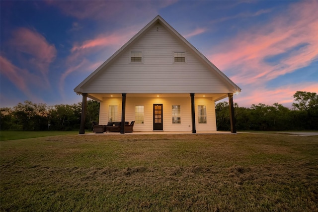 view of front of home featuring a lawn and a patio area