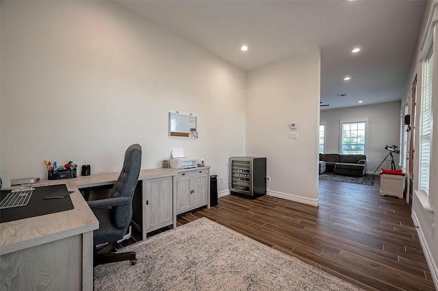 home office featuring dark hardwood / wood-style flooring and beverage cooler