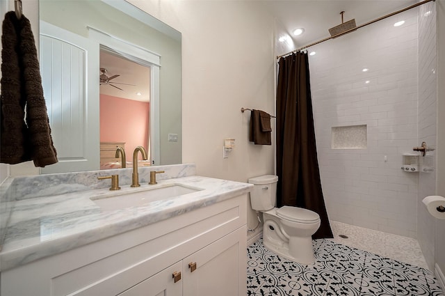 bathroom featuring a shower with shower curtain, vanity, ceiling fan, tile patterned flooring, and toilet