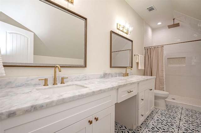 bathroom featuring tile patterned floors, toilet, vanity, and walk in shower