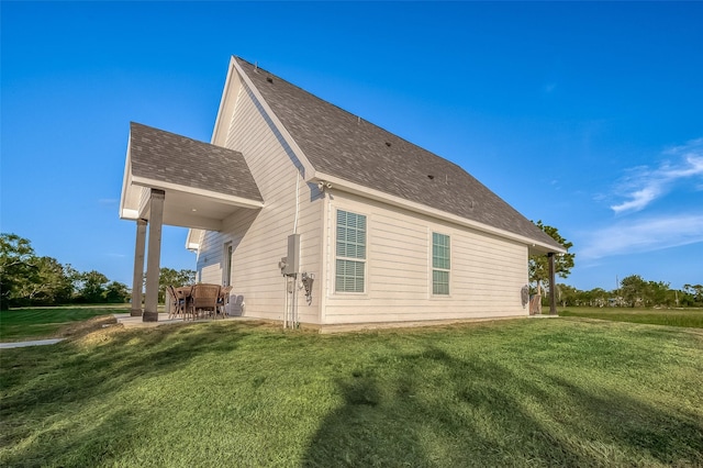 view of home's exterior with a yard and a patio area