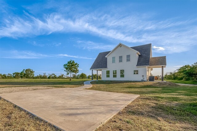 back of property with a lawn and central AC