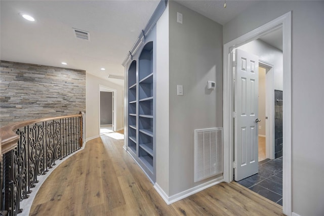 hallway with dark hardwood / wood-style floors and built in features