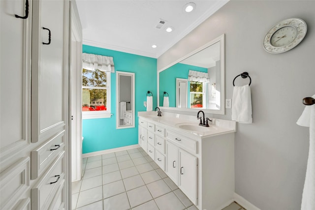 bathroom with tile patterned floors, vanity, and crown molding