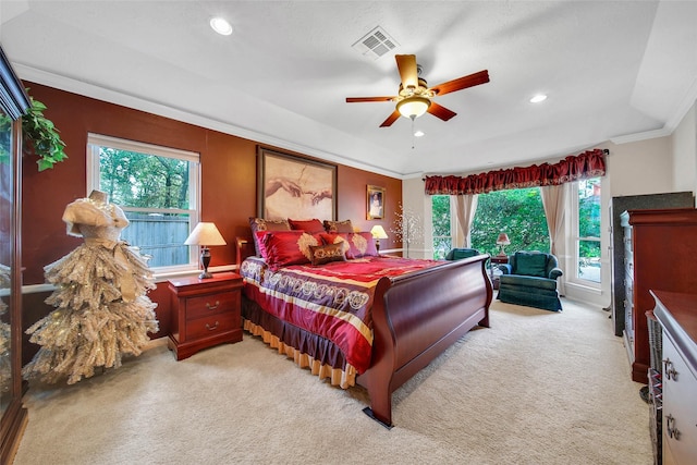 bedroom featuring light carpet, multiple windows, ceiling fan, and ornamental molding