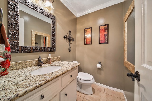 bathroom with toilet, vanity, tile patterned floors, and crown molding