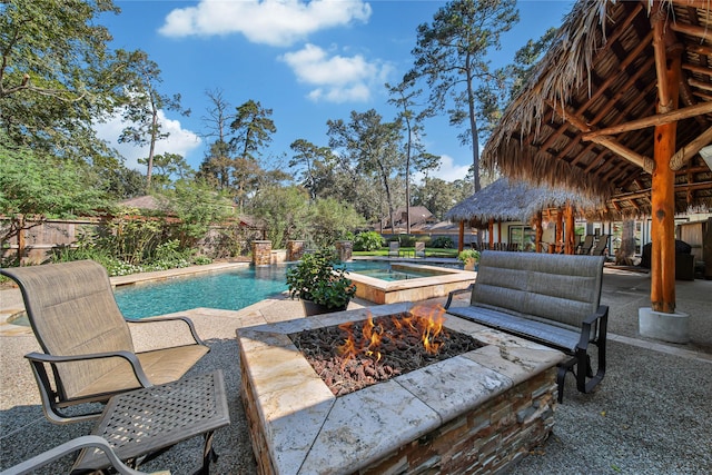 view of pool with a grill, a patio, and an outdoor fire pit