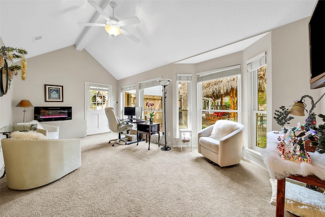 carpeted home office with ceiling fan and lofted ceiling with beams