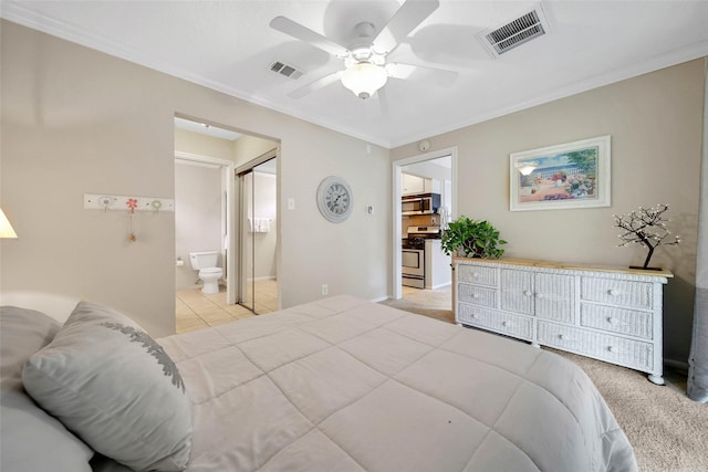 bedroom featuring ceiling fan, light colored carpet, ornamental molding, and connected bathroom