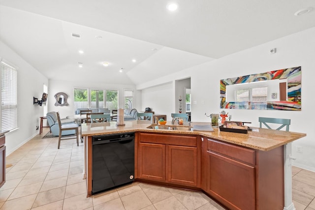 kitchen featuring lofted ceiling, dishwasher, a center island with sink, and sink