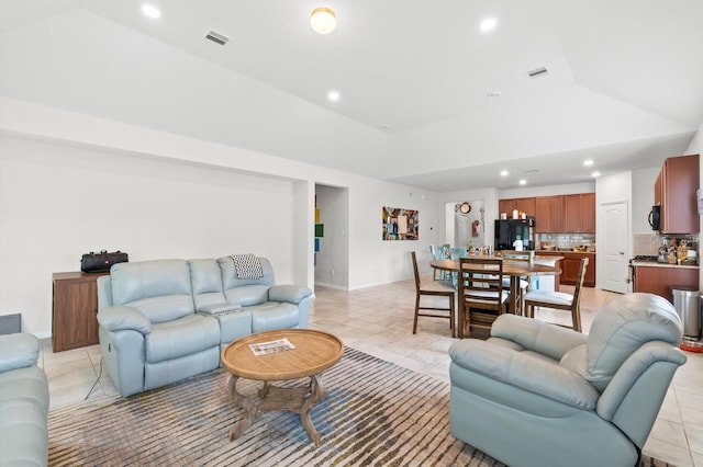 tiled living room featuring vaulted ceiling