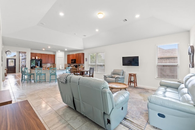 tiled living room with a tray ceiling