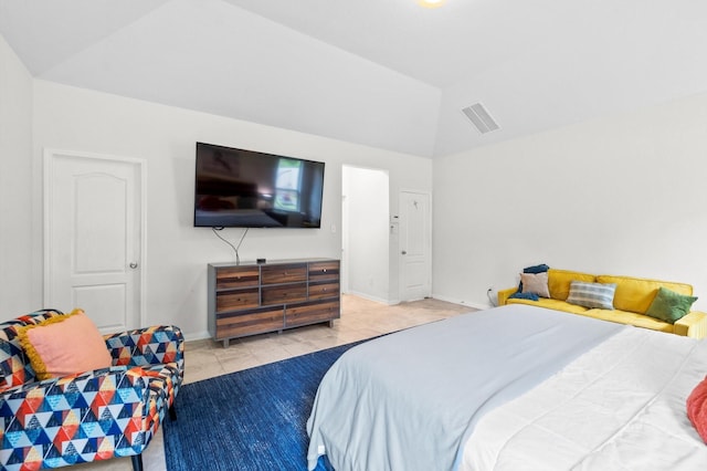 bedroom with lofted ceiling and light tile patterned flooring