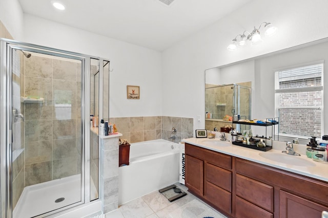 bathroom featuring tile patterned floors, vanity, and separate shower and tub