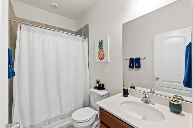 bathroom with vanity, a shower with shower curtain, and toilet