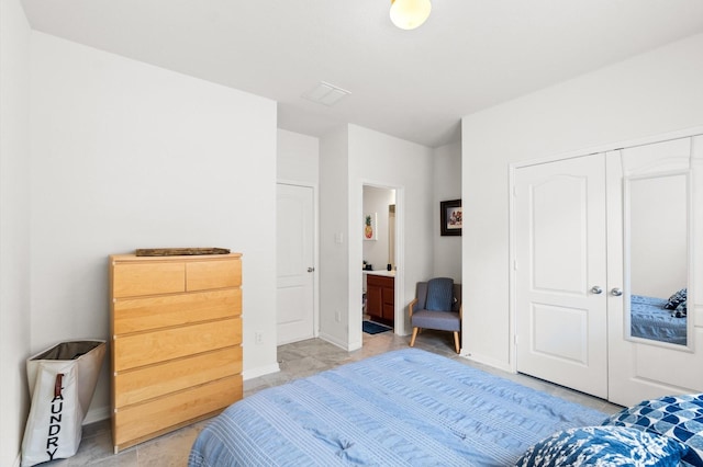 bedroom with ensuite bathroom and a closet