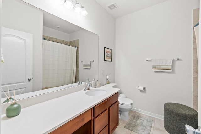 bathroom featuring tile patterned flooring, vanity, toilet, and walk in shower