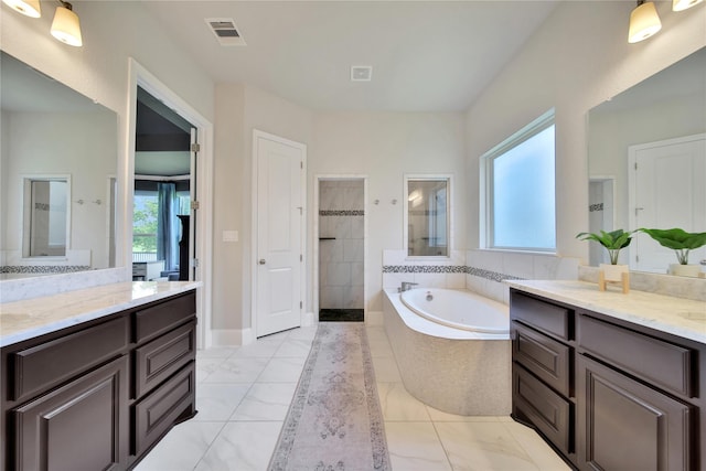 bathroom featuring tile patterned floors, vanity, and separate shower and tub