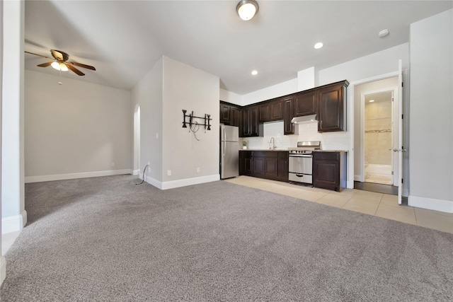 kitchen featuring dark brown cabinets, ceiling fan, light colored carpet, and appliances with stainless steel finishes