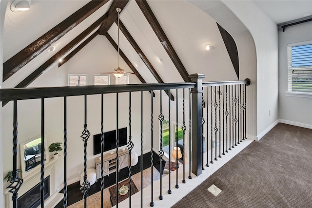 staircase with carpet flooring, vaulted ceiling with beams, and ceiling fan