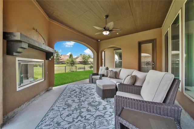 view of patio with ceiling fan and an outdoor living space