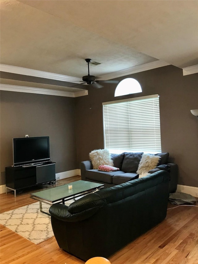 living room with ceiling fan, light hardwood / wood-style floors, plenty of natural light, and ornamental molding