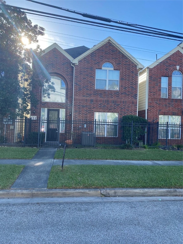 view of front facade featuring a fenced front yard and brick siding