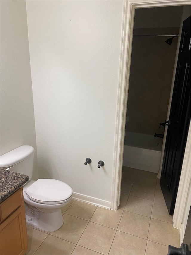 full bath with baseboards, toilet, tile patterned flooring, vanity, and shower / washtub combination