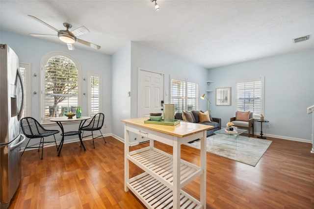 dining area with hardwood / wood-style floors and ceiling fan