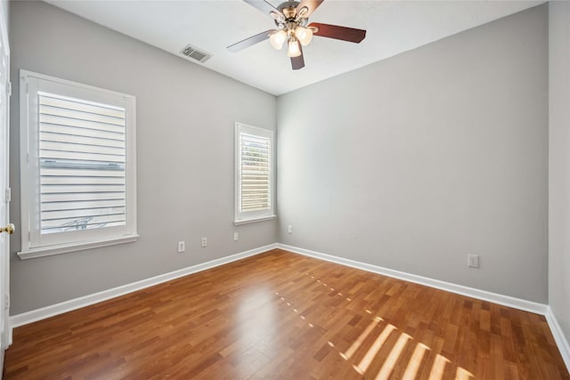 spare room featuring wood-type flooring and ceiling fan