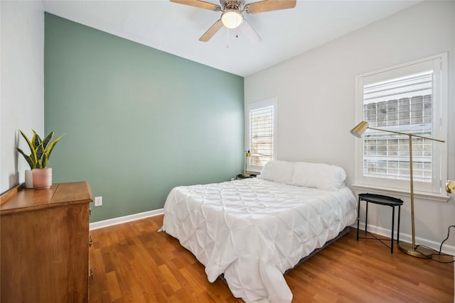 bedroom with ceiling fan and hardwood / wood-style flooring