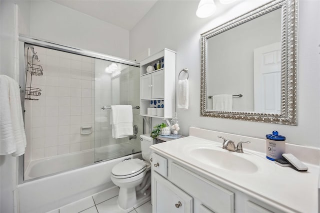 full bathroom featuring tile patterned flooring, vanity, toilet, and shower / bath combination with glass door