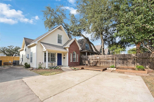 view of front of property featuring a wooden deck and cooling unit