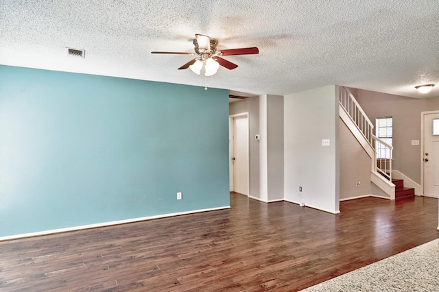 unfurnished room with a textured ceiling, ceiling fan, and dark hardwood / wood-style floors