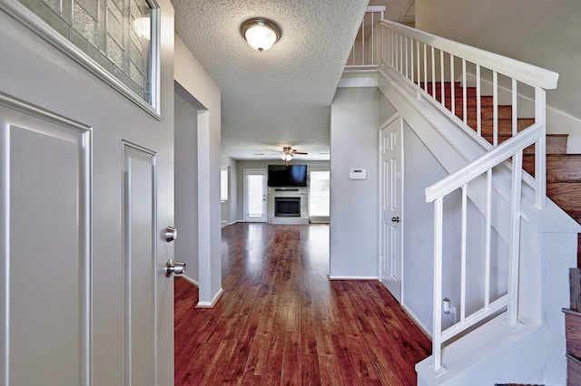 entrance foyer featuring dark hardwood / wood-style flooring and a textured ceiling