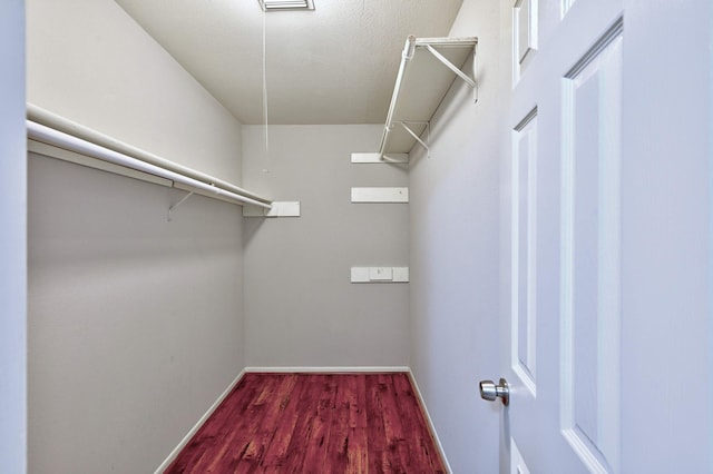 spacious closet featuring hardwood / wood-style floors